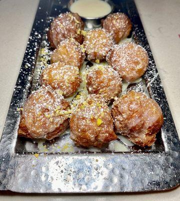 Thai donut holes with sugar glaze and pistachio sprinkles