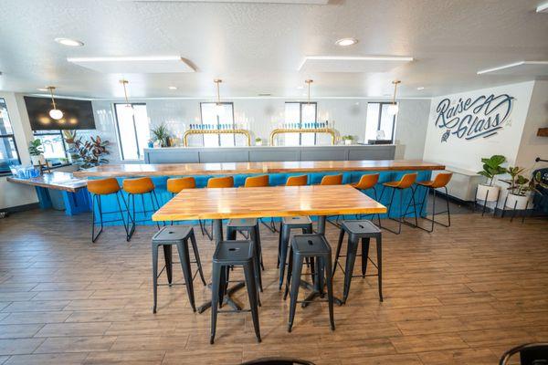 Interior with artisan crafted tap handles, bar top, and local art