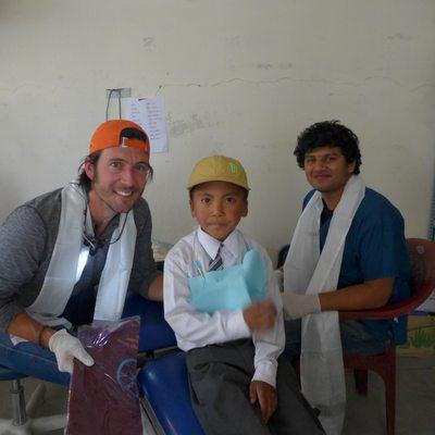 Dr. Roach with translator Abraham and a Tibetan school boy after receiving ceremonial scarf in Tibet, 2015