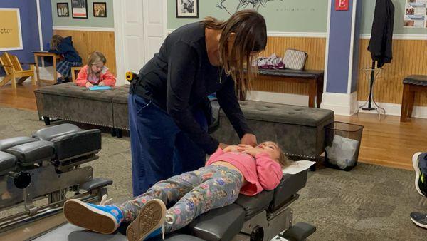 Dr. Rebecca checking a child for nerve interference.