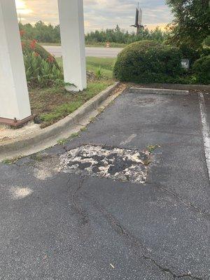 Weeds and grass and potholes numerous in the parking area. The entrance light does not work at night.