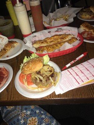 Burger with grilled onions and garlic bread