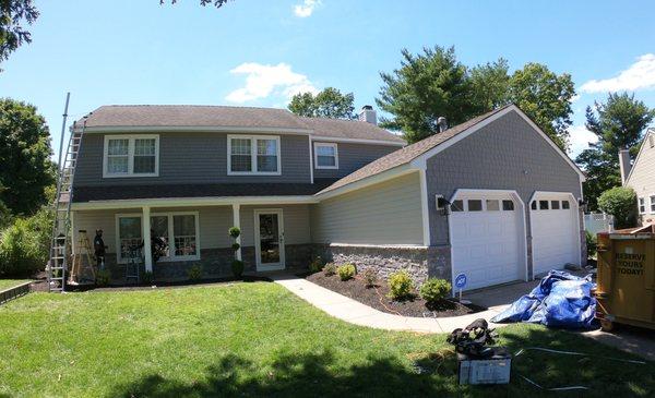 Finished siding job with stone façade.