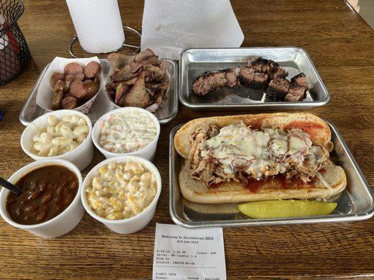 Sausage, brisket, burnt ends, mac and cheese, coleslaw, beans, cheesy corn, large pulled pork sandwich with pepper jack and grilled onions