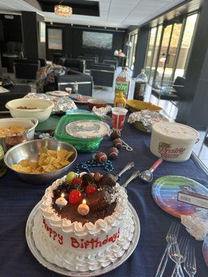 The tres leches cake with candles for our two birthdays on the same day.