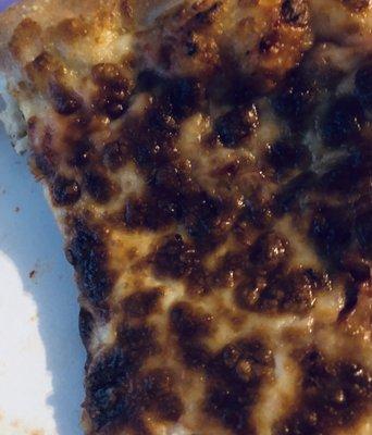 Burnt plastic cheese pizza