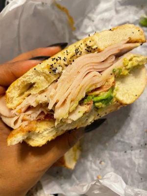 Turkey avocado bagel sandwich on everything bagel