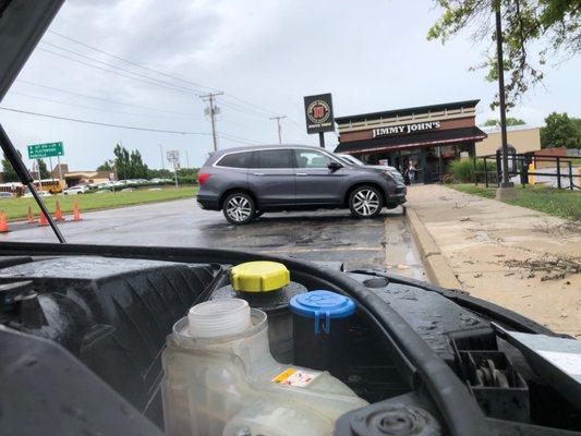 Parked in front of Jimmy John's with my car overheating second time, after mechanics failed to burp it.