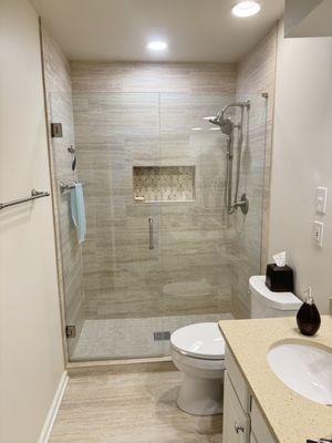 Walk in shower bathroom renovation frameless glass, and ceramic tiles, Kohler fixtures, ceramic tile floor .