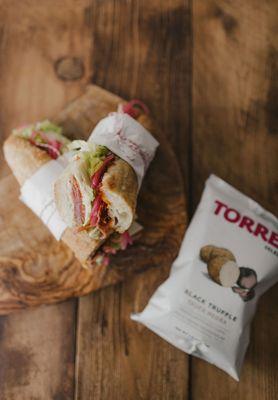 Each sandwich comes with Torres Black Truffle Potato Chips