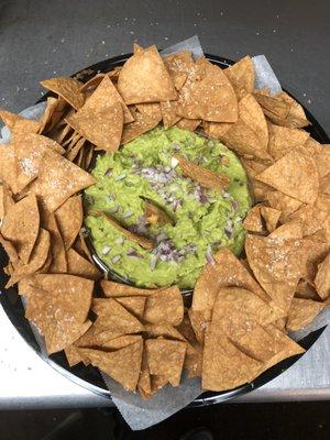 Guac and fresh corn chips Mexican made for authenticity