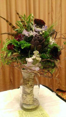 This Beauty won in a bridal bouquet show for " Colorado bridal" featuring   organic herbs ,artichokes ,pheasant feathers with bark wrap