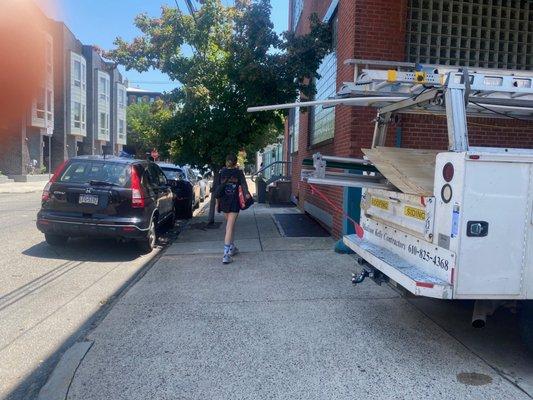 Illegal parking with sharp metal objects obstructing the pedestrian side walk