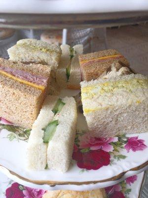 Tea sandwiches curried eggs salad, almond chicken salad, ham and cheese with champagne mustard.