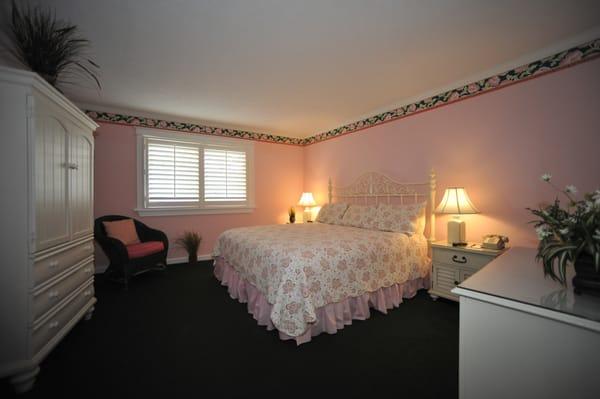 Island View One King Suite. This view shows the separate bedroom area with a window view that overlooks the homes on Market Street.