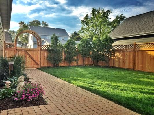 Privacy fence with lattice and arbor.