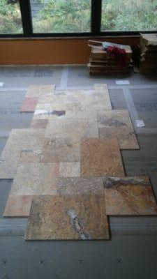 Travertine tile being placed. After  sub floor leveling  & 1/4" durarock   installed to ensure a stable base for the flooring...