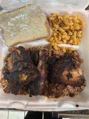 Jerk chicken with dirty rice and macaroni and cheese.