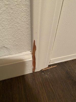 Broken door trim compliments of the installer.  Fixed by rugworks with putty and paint, not matching at all