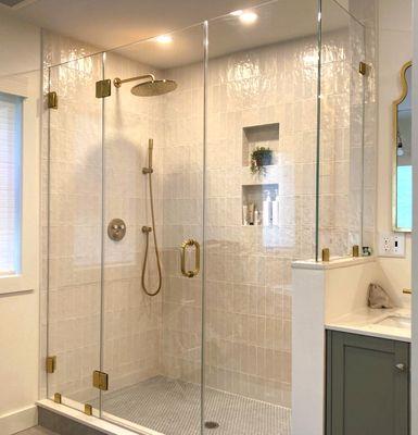 Centered shower door with satin brass hardware