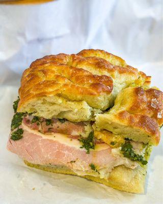 The Porchetta sandwich (porchetta, gorgonzola dulce schmear, pork rinds, salsa verde).