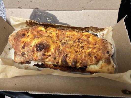 Stuffed cheesy bread. Burnt on the bottom.