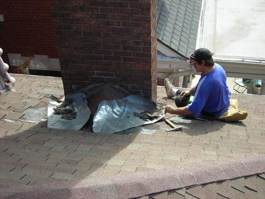 Brick chimney in the process of being reflashed to stop leaks.