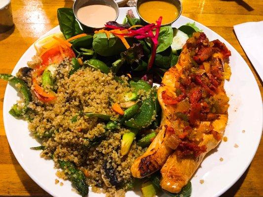 Broiled salmon steak with sundried tomatoes. Served with quinoa, peppers, asparagus and salad.