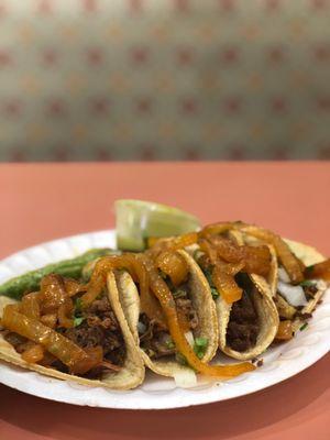 Four kinds of tacos, Barbacoa, beef, chicken, and shredded pork, made in the traditional style