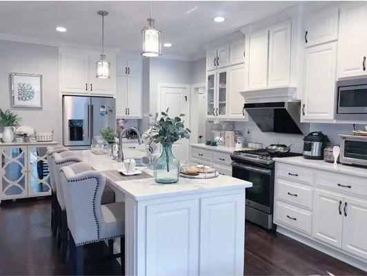 White cabinets with black hardware, and a dark brown flooring to add some warmth to the home