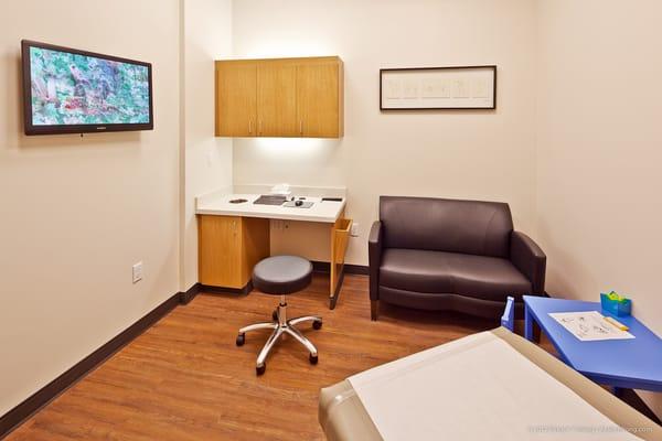 Exam rooms with flat screen TV, couch and Wi-Fi.