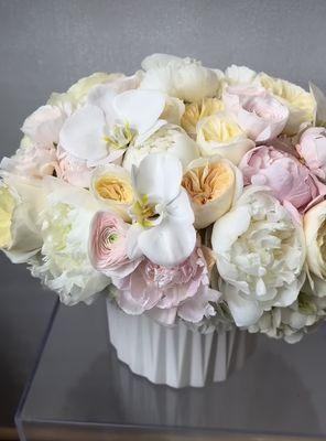 Large soft blushing neutral arrangement featuring phalaenopsis orchids, ranunculus, peonies, and garden roses