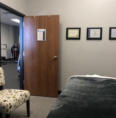 A view from inside the massage room. As you exit this door the entrance is to the left, bathrooms to the right.