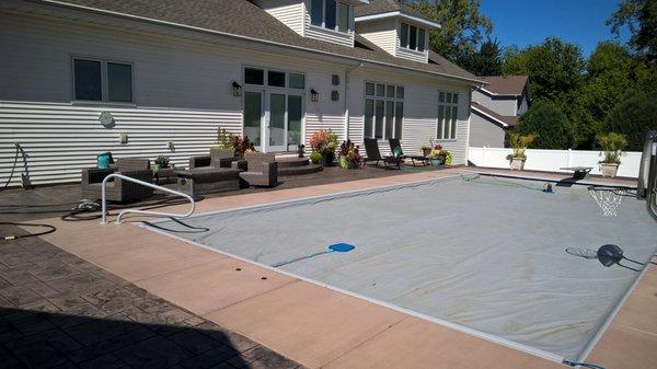 Colored concrete deck around fox auto cover pool.