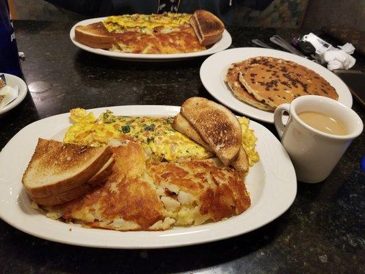 Greek Omelette with hashbrowns and rye, with a short stack of pancakes for the table