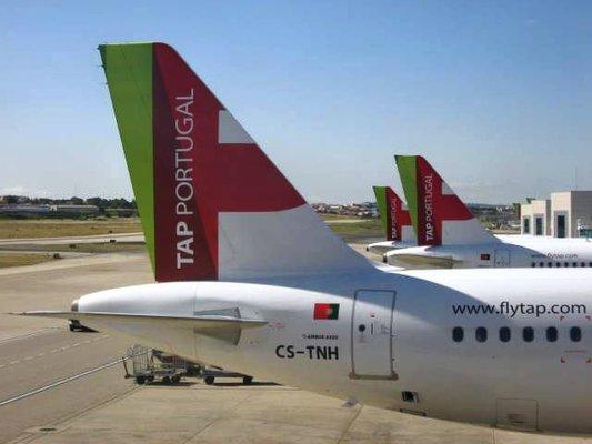 A series of smaller TAP Airbus planes at nearby gates at LIS, where landing and taking off in the beautiful weather makes for great vistas.