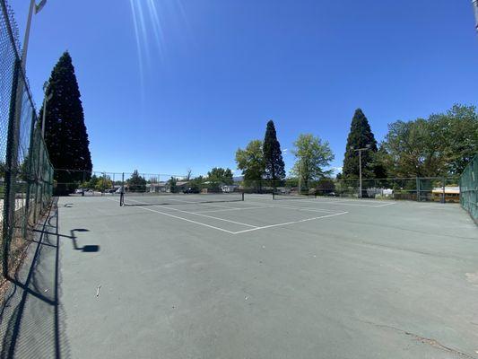 Tennis court with fence around it.