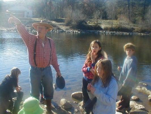 These students are learning about the California gold rush. We are right at the river panning for gold.