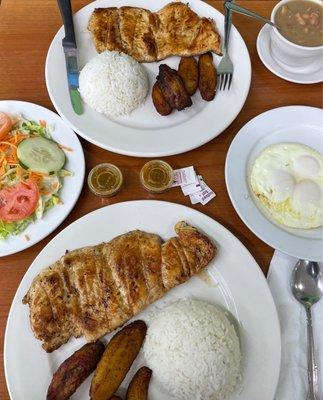 Two Grilled Chicken Breast platters with sides for dinner.