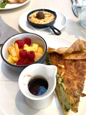 Quiche with fruit salad  with fondue in background