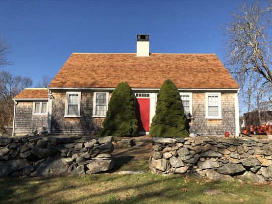 New red cedar roof appropriately covers this 1700s farmhouse.