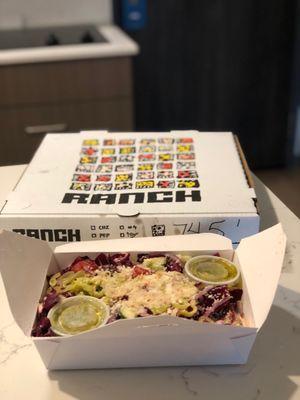 Radicchio Caesar salad and the pepperoni pizza in the box