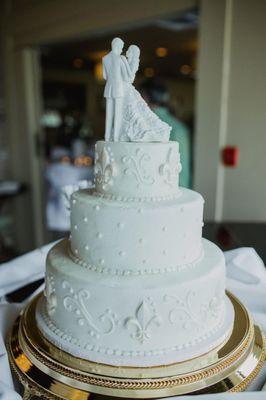 Almond-flavored wedding cake with buttercream icing and white-chocolate fleur de lis.