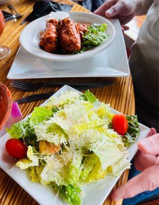 Delicious buffalo wings and side Cesar salad