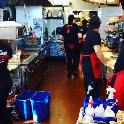 Busy workers making sandwiches.