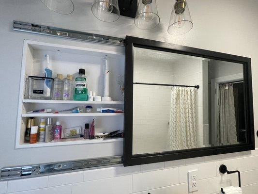 Custom vanity with hidden outlet to charge electric tooth brushes. They are finally hidden away!