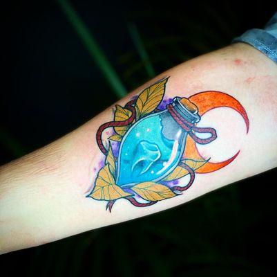 Tooth in a bottle tattoo