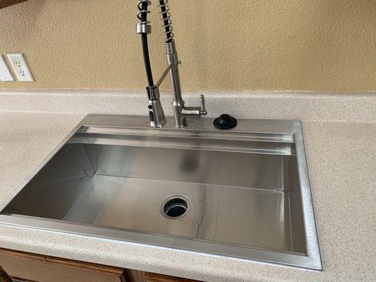 After: customer supplied drop in sink install, with company supplied garbage disposal replacement. Call us today (512)753-9457