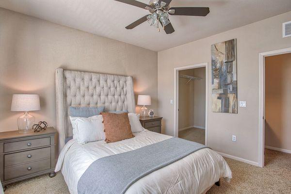 a bedroom with a bed and a ceiling fan at Spring Creek Apartments