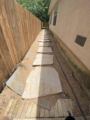 The entrance to the backyard. We lost so much crushed granite that it left the cover they put underneath exposed.